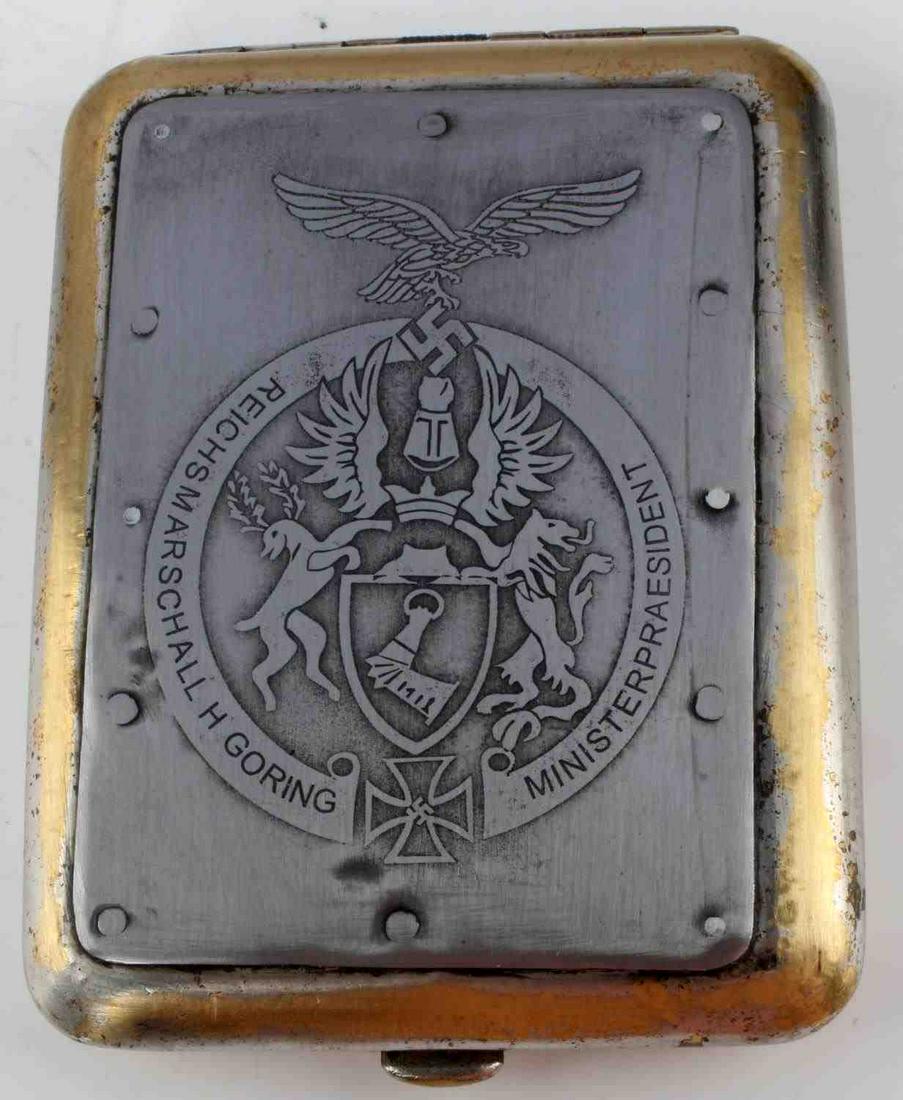 WWII GERMAN 3RD REICH CIGARETTE CASE GORING CREST: Measures 3.5 inches by 4.5 inches, Hermann Goring family crest engraved on the front. WaA142 stamped on the inside leather. Unauthenticated, sold as is. This lot has a reserve.