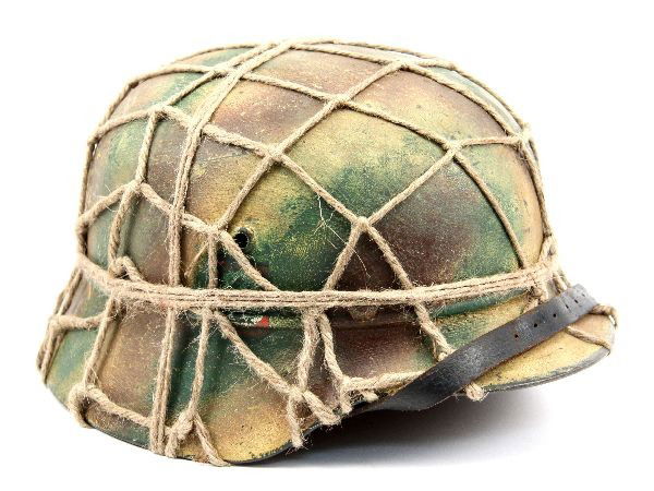 GERMAN M35 WWII FIELD POLICE HELMET CAMO REPAINT: German M35 Field Police helmet shell. Double decals of police eagle and party shield visible through camouflage repaint. Shell has been repainted, liner replaced, and netting added later. All except s