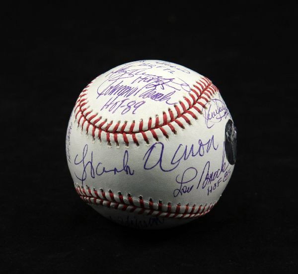 HALL OF FAME BASEBALL SIGNED BY 15 INDUCTEES: A steiner authenticated baseball with the autographs of 15 HOF players on it. Included are Hank Aaron, Yogi Bera, Whitey Ford, Jonny Bench, Duke Snider and and 10 others. Excellent condition. Hologram