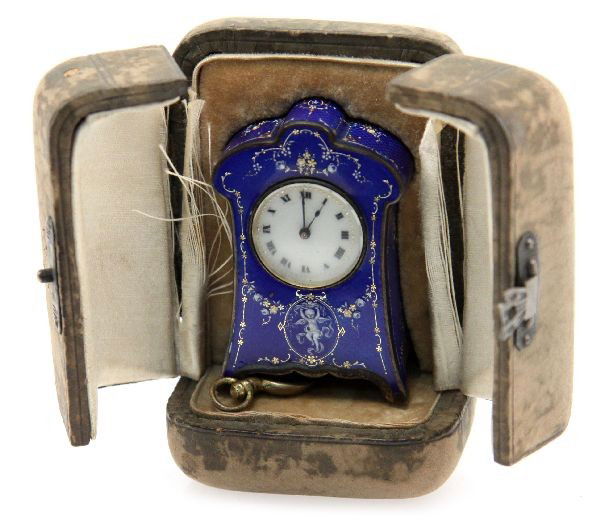 MINIATURE ARGENT DORE CLOCK IN FITTED CARRY CASE: Standing a mere 2 inches tall and 1.5 inches wide. Beautiful blue enamel finish. Serial number 2890B and dated 1903 on the movement. Original key is present. Fitted travel case in very good condition.