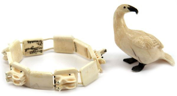 ALASKA CARVED IVORY SIGNED BRACELET & FIGURINE: A beautifully hand carved antique Alaskan Diomede island signed Dwight Milligrock , depicting sled and sled dogs, the second piece is a hand carved Goose. . Condition: Very good
