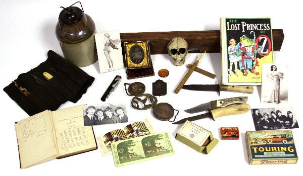 ANTIQUE LOT KNIVES TOOLS CROCK SKULL & MORE: A box full of surprises from a possible cast iron Fraternal door skull, to books and more, there is a rare Baker Mcmillan leveler, a olive growers crock, a collection of antique magic tricks and games