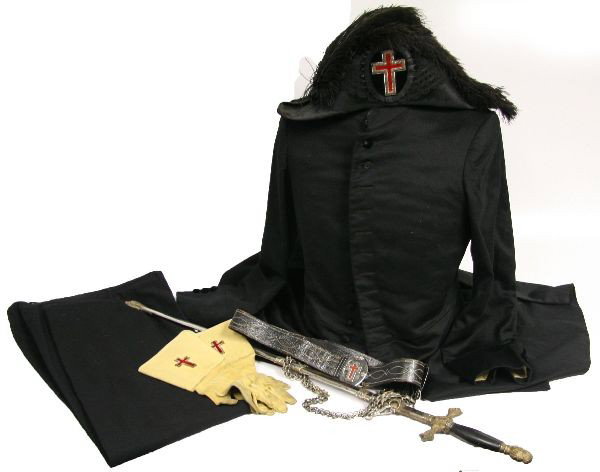 KNIGHTS TEMPLAR SWORD BICORN HAT GLOVES & UNIFORM: A Knights Templar grouping consisting of a Bicorn hat, cavalry gloves, a coat and a sword with belt , sword is named to Carl Hartig, all items are very good.