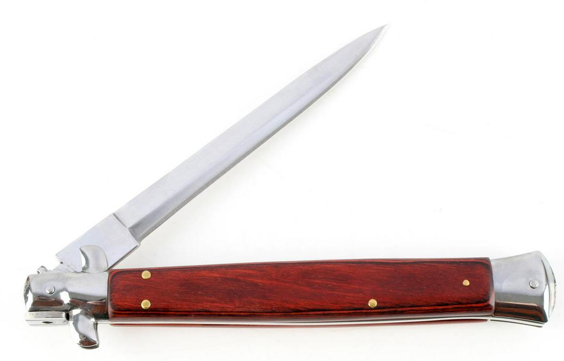 ITALIAN MADE AKC SWITCHBLADE KNIFE RED OAK WOOD: AKC knife with stainless steel blade, red dyed wood grip, and brass accents. Measures 13 inches. Very good condition.
