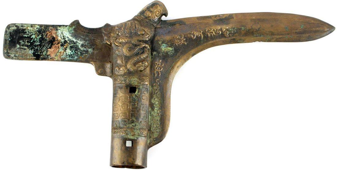 ANCIENT CHINESE BRONZE CEREMONIAL DAGGER AXE: Ancient Bronze Age dagger axe from China. Features bird on top with snakes on both sides. Writing chases the blade. Measures 13 1/8 inches. Non-magnetic. Very good collectible grade. This lot has a re
