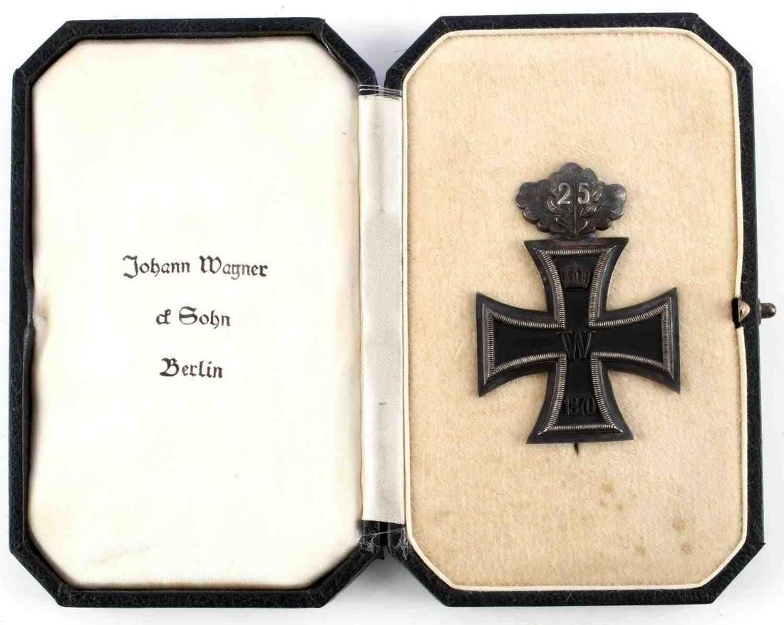 FRANCO PRUSSIAN WAR 1870 1ST CLASS IRON CROSS: Franco-Prussian War 1870 1st class iron cross with 25 year anniversary oak leaves in silver. Comes in original Johann Wagner & Sohn Berlin award case. 25 year oak leaves have been soldered on with sil