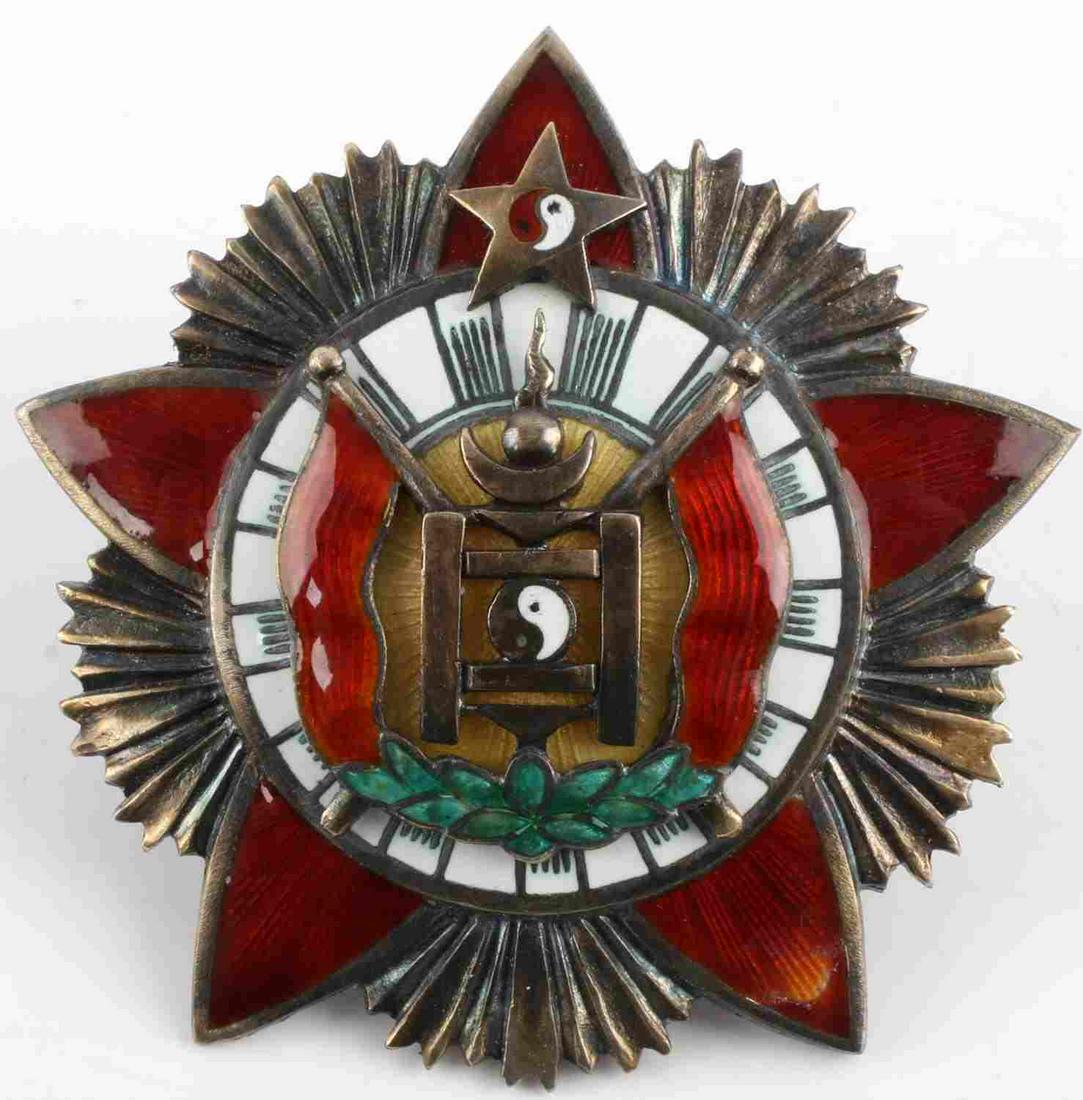 SILVER MONGOLIAN ORDER OF THE RED BANNER MEDAL: Mongolian Order of the Red Banner medal. Features Soyombo symbol with red flags surrounded by roundel. Multipiece construction with symbol being pinned to silver back plate. Red, white, and green enam