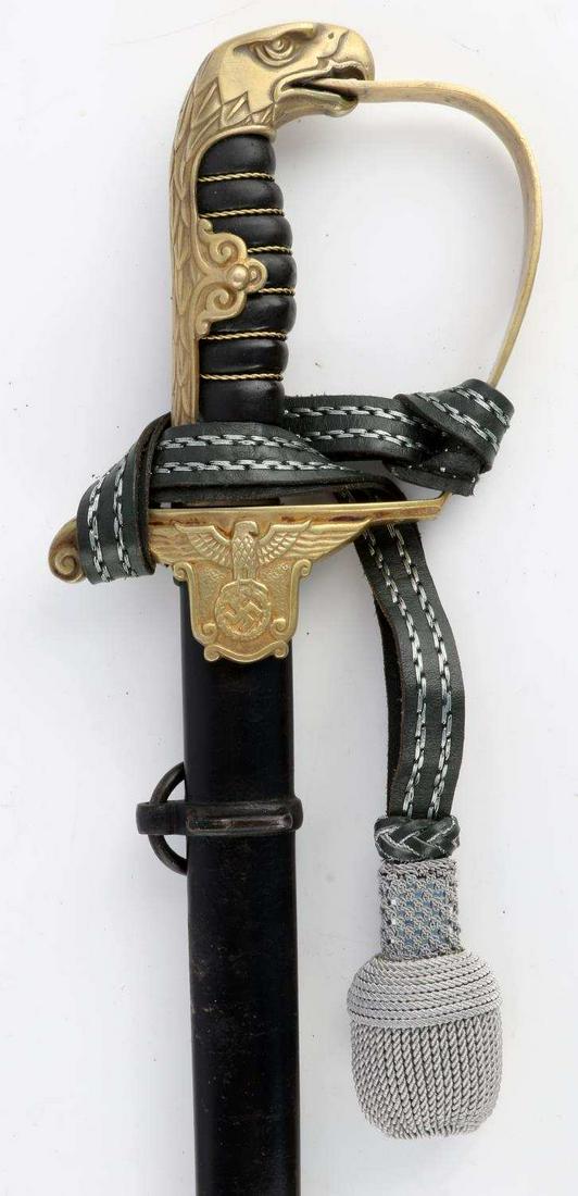 WWII GERMAN THIRD REICH PRISON OFFICIAL SWORD: Measuring 37 1/2 inches overall with a 31 3/4 inch lightly curved single fuller blade bearing the Eickhorn squirrel logo on the left ricasso. The brass hilt deviates from the traditional stirrup guard