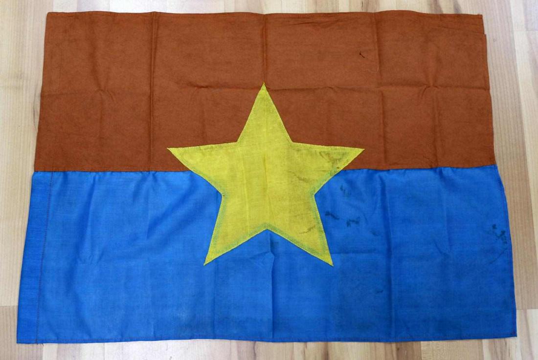 VIETNAM ERA VIET CONG COMBAT BATTLE FLAG: Vietnam Era Army Viet Cong VC Combat Battle Flag. Measures 29” wide by 21 5/8" wide. Has a yellow star in the center. Three piece machine embroidered and machine sewn on a blue and orange cotton fla