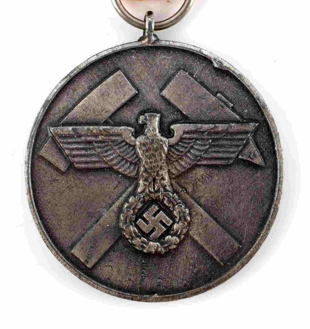 WWII GERMAN THIRD REICH MINER RESCUE SERVICE MEDAL: German WWII Mine Rescue Service Decoration. Measures 3/8 inches diameter. The front shows a German eagle clutching a swastika in his talons. There are two mining hammers in the back ground. The revers