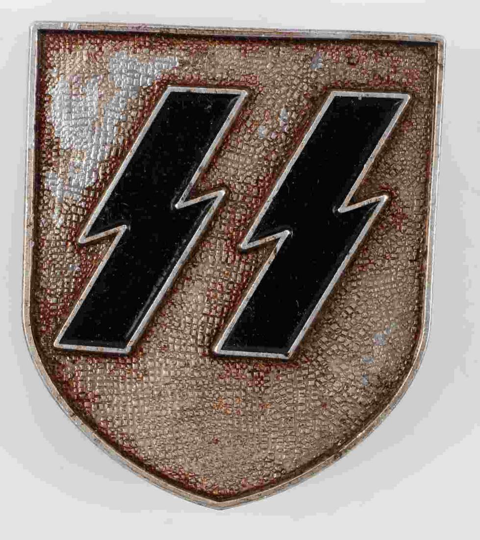 WWII GERMAN THIRD REICH SS PITH HELMET PIN: German WWII Waffen SS Schutzstaffel Pith Helmet Shield. Measures 1 1/2" wide by 1 11/16” inches tall. The front shows a pair of Waffen SS runics in the center of the shield. The reverse side is make