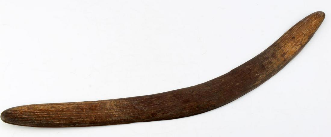 ANTIQUE ABORIGINAL MADE BOOMERANG: One side is convex the other flat, thus probably not a utilitarian Boomerang, has scrapings indicating aboriginal made, has small chip on flat side and a fracture on the convex side. Measures 22 inche