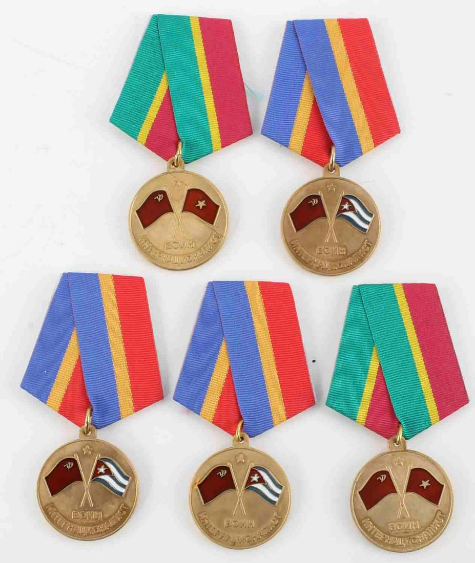 LOT 5 USSR RUSSIAN VETERAN OF FOREIGN WARS MEDALS: 3 Cuban service medals some for bay of pigs service, 2 Vietnam service medals. Unauthenticated, sold as is. This lot has a reserve.