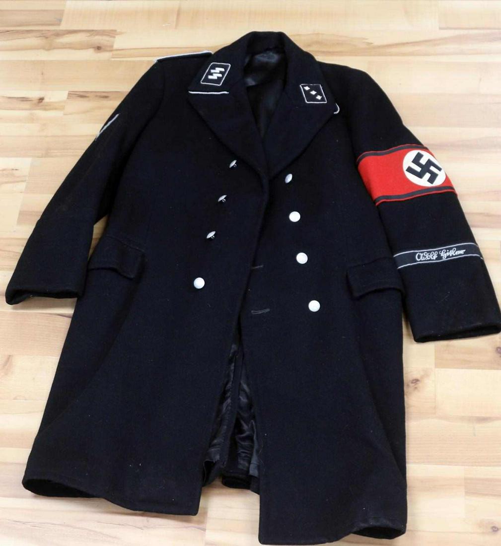 WWII GERMAN ALLGEMEINE SS ADOLF HITLER TUNIC: WWII German Allgemeine SS black wool tunic. SS-Untersturmführer rank collar tabs. Twisted wire shoulder boards. Party armband to the left arm featuring a black swastika inside a fluorescing white rou