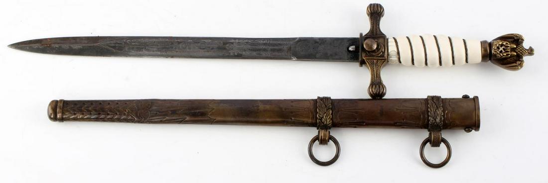 WWII GERMAN KRIEGSMARINE DAGGER W SCABBARD: WWII German Kriegsmarine Model 2 dagger with lightning bolt scabbard. Nickel pommel and and crossguard featuring the Reichsadler and anchor. Off-white celluloid grip with twisted wire. Blade etched na