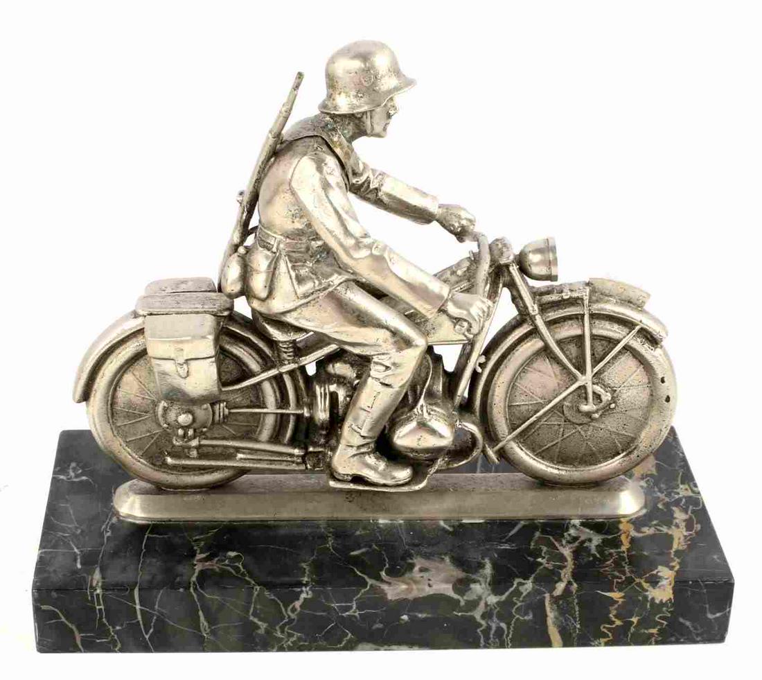 WWII GERMAN BIKER MOTORCYCLE DESK DECORATION: WWII German desk decoration featuring a German biker riding a motorcycle with a black marble base. The biker has a Mauser on his back with a double decaled helmet. Some play between with the soldier a