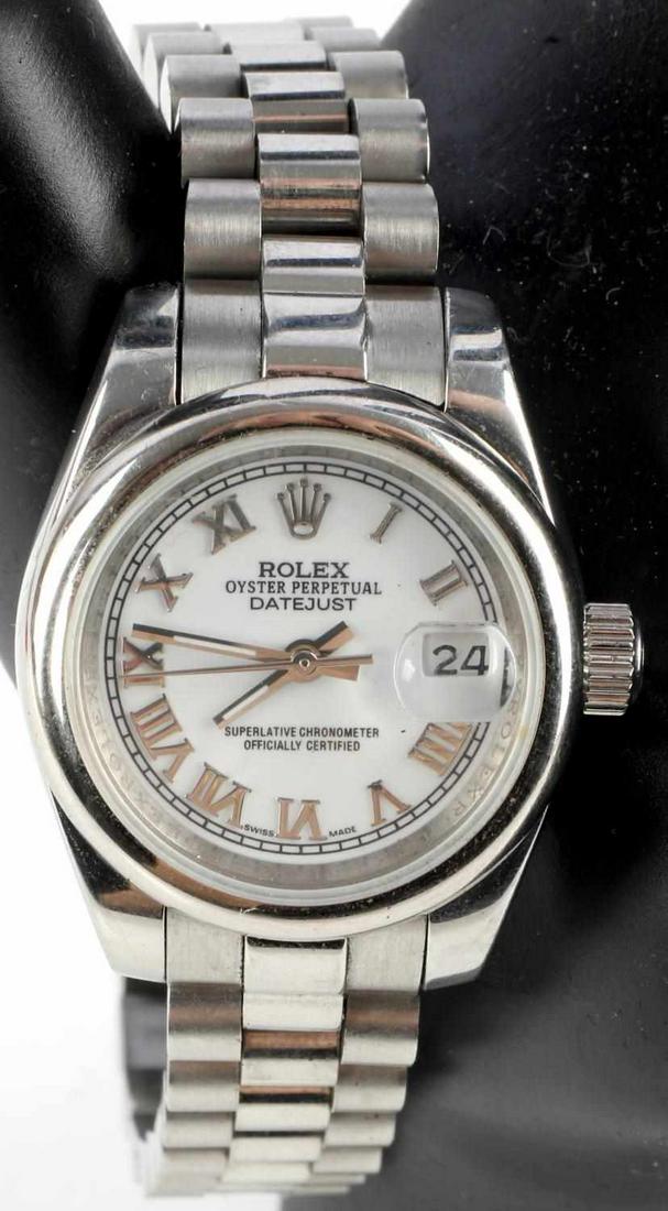 LADIES 18K WHITE GOLD ROLEX DATEJUST WHITE DIAL: Watch is a ladies 28 millimeter Datejust. Dial is white and silver with Roman Numeral hour markers and a date window at 3 o'clock. Watch is a 2004 model. Bracelet is Presidential with all original lin