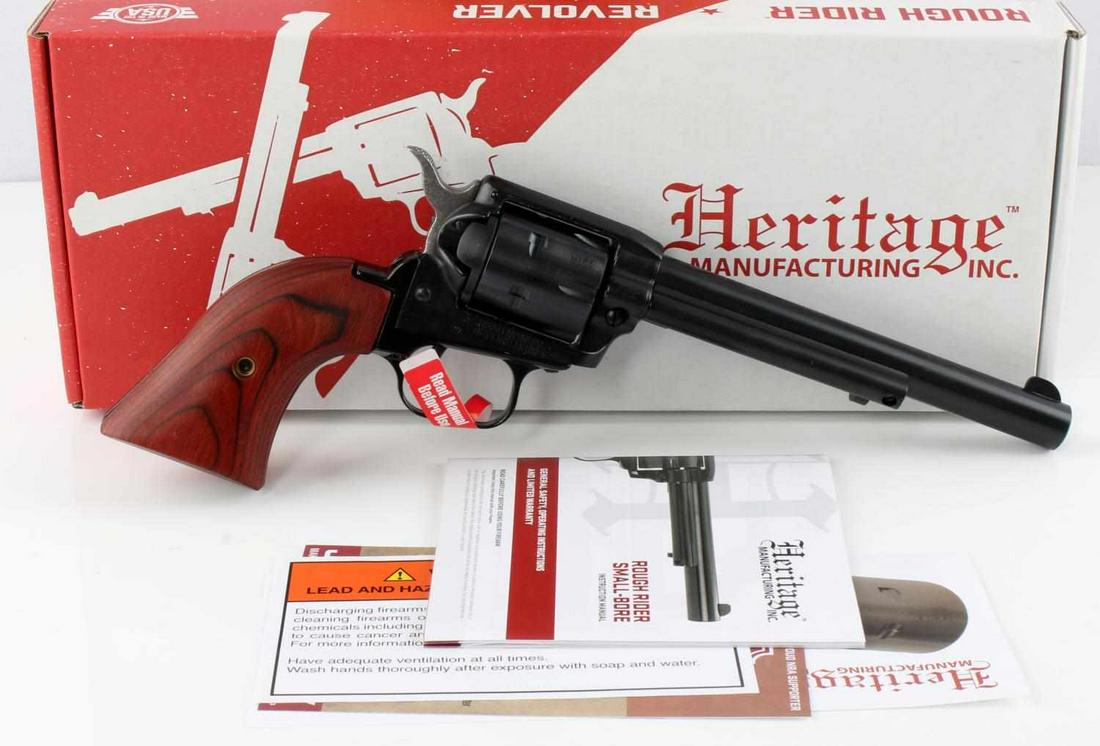 HERITAGE ROUGH RIDER .22 CAL 6 SHOT REVOLVER NIB: Blued steel, red wood grips, 6.75 inch barrel, mint bore, clear markings, comes new in box with manual, and lock and key. Requires FFL for transfer. No international shipping. Caliber: .22 LR Serial #