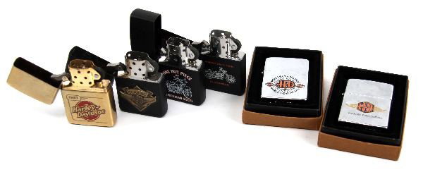 VINTAGE HARLEY DAVIDSON MOTORCYCLE ZIPPO LIGHTERS: A collection vintage lighters, including a Harley Davidson "More Than A Machine" zippo in box, a Harley Davidson logo with wings zippo in box, a 1983 Harley Davidson zippo, a Harley Davidson "Classic"