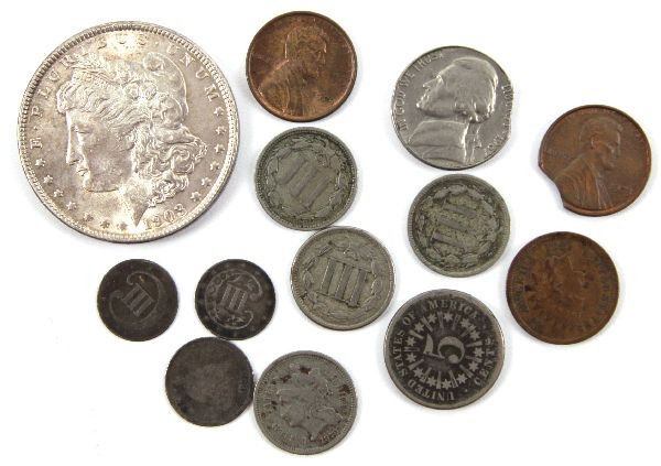 US COIN COLLECTION SILVER 3 CENT MORGAN ERROR MORE: A useful variety of U.S. coinage consisting of: (2) clip errors, 1973 penny, 1967 nickel, 1881 Indian in XF, 1909 VDB penny in AU, 1903 Morgan silver dollar in UNC, 1860 silver 3 cent piece in F, plus