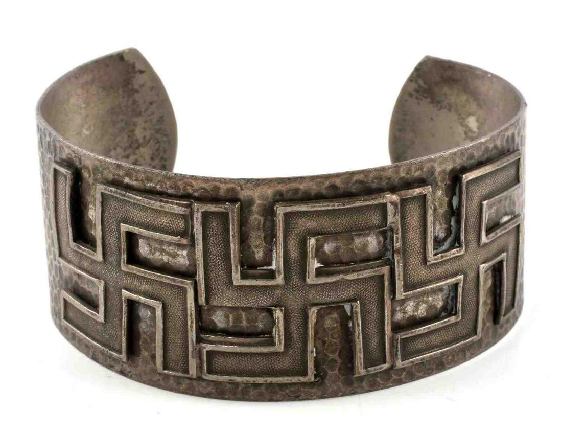 VINTAGE BUDDHIST OR HINDUISM SWASTIKA BRACELET: White metal construction. Features 3 right facing swastikas which could indicate Hinduism, Jainism, and Sri Lankan Buddhism. Measures 2 1/2 inches in diameter. Very good condition.