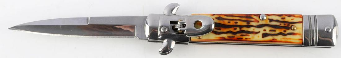 SPRING ACTION LOCKING SWITCHBLADE KNIFE STAG GRIP: Spring action switchblade knife with simulated stag grip. Measures 7 3/4 inches. Very good condition.