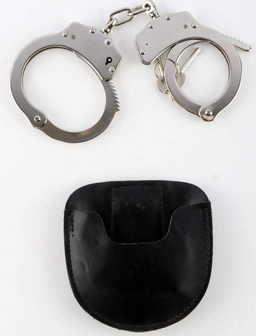 VINTAGE SMITH AND WESSON HANDCUFFS W CASE AND KEYS: Steel handcuffs with leather Smith & Wesson carrying case. Measures 9 inches. Comes with 2 keys. Very good condition.