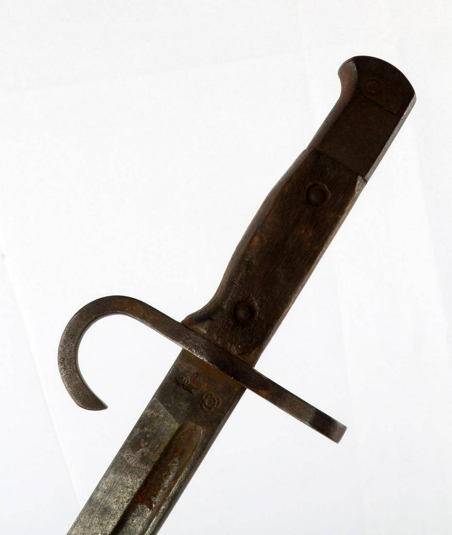 WWII JAPANESE ARISAKA TYPE 30 BAYONET: 15.25 inch blade with Matsushita Kinzoku Arsenal markings at ricasso, steel fittings, and wood grip. Oxidation and patina, good condition.