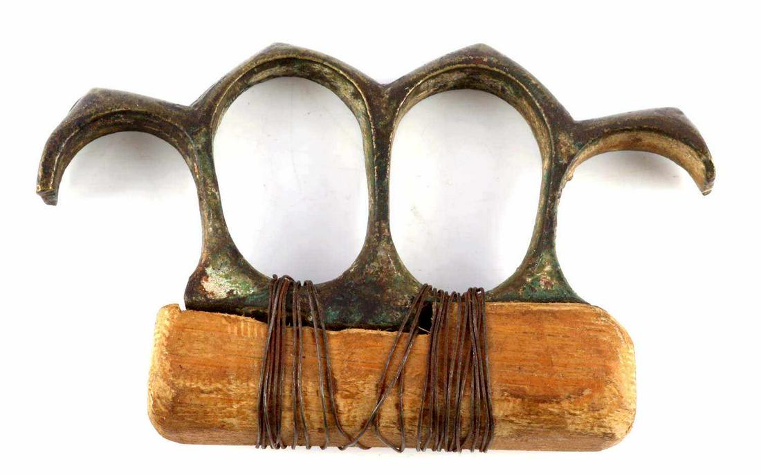 WWI US MILITARY TRENCH ART BRASS KNUCKLES: US military trench art repurposed brass knuckles. Brass construction. Original piece was broken and handle replaced with wood. Measures 4 x 2 1/2 inches. Good condition.