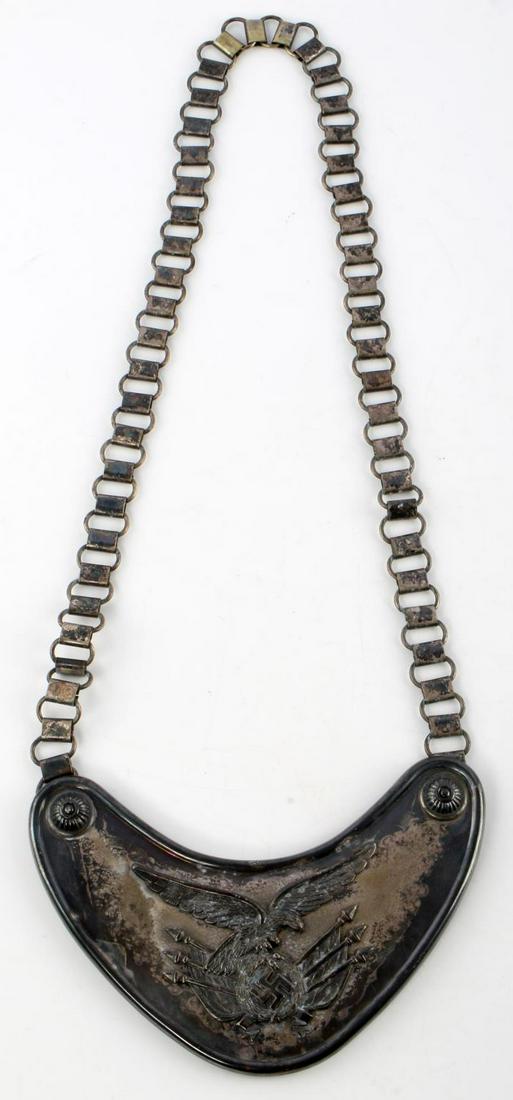 WWII GERMAN THIRD REICH LUFTWAFFE STANDARD GORGET: WWII German Reich Luftwaffe standard bearers gorget. Features Luftwaffe eagle clutching swastika and flags. Segmented chain. Assmann maker on reverse. Measures 6 3/4 inches. Unauthenticated, sold as i