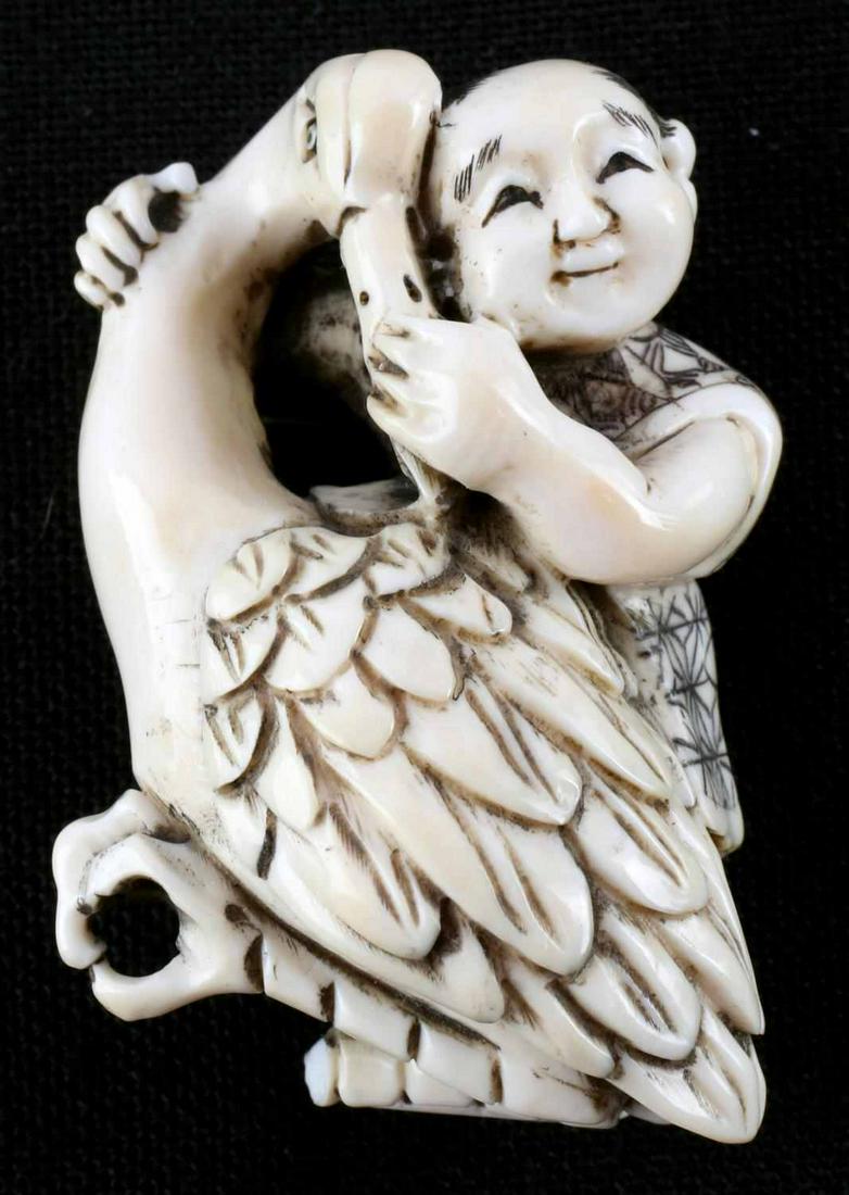 MEIJI PERIOD JAPANESE SCULPTED IVORY NETSUKE: Meiji Period (late 19th - early 20th century) Japanese Netsuke featuring boy with crane is signed and measures 1 3/4 x 1 1/4 inches with no cracks, chips or repairs. Over 100 years old. PLEASE KNOW YO