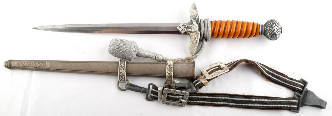 WWII GERMAN SECOND MODEL LUFTWAFFE DRESS DAGGER: WWII German Reich second model Luftwaffe dress dagger with portapee, scabbard, and dagger hanger. Blade measures 10 1/4 inches long and possesses some light pitting and service wear. Crossguard and po