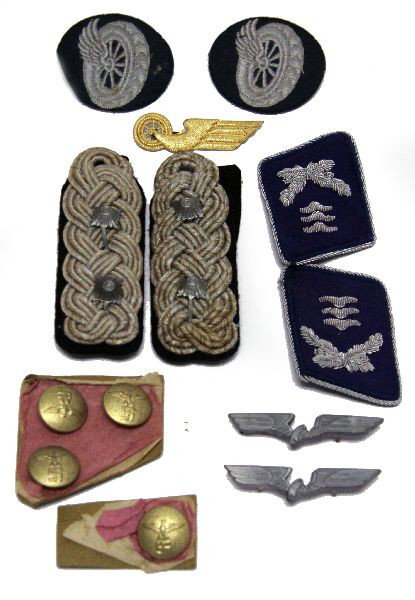 WWII THIRD REICH INSIGNIA & BUTTON COLLECTION: A collection interestingly contained in an original tattered Feldpost box consisting of Luftwaffe collar tabs, Luftwaffe shoulder straps, NSDAP coat buttons, National Railway insignia, all 100% origin