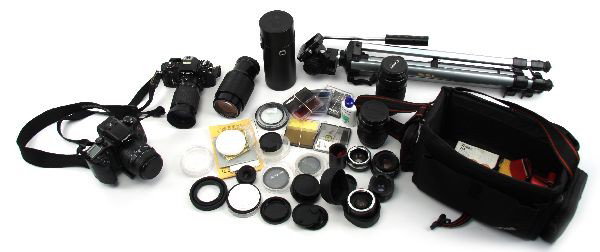 LARGE LOT OF VINTAGE CAMERAS LENSES & EQUIPMENT: A collection of vintage cameras and equipment, including: a Cannon Elan 7E SLR 35mm camera with Sigma 28-80 F3.5-5.6II lens, a Cannon 75-300mm F4-5.6 lens, a Cannon 28-80mm F3.5-5.6 lens, tripod, stra