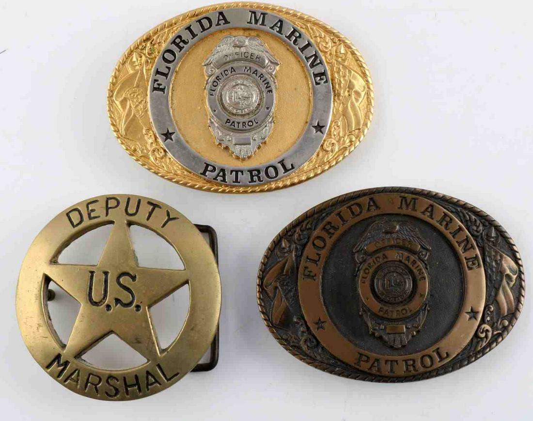 LOT OF 3 LAW ENFORCEMENT BELT BUCKLES US MARSHAL: Lot features 2 Florida Marine Patrol and Deputy U.S. Marshal. The name for one of the Marine Patrol buckles has been filed off. The Deputy Marshal buckle is numbered 606. Measure 2 3/4 - 3 1/2 inches.