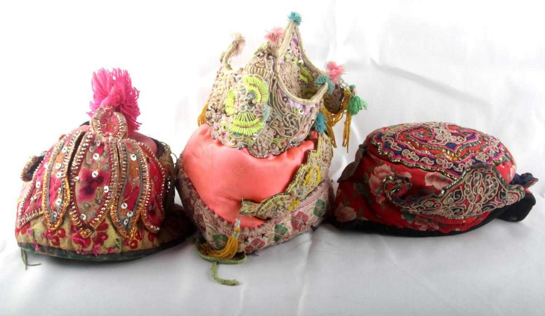 3 ANTIQUE CHILDRENS CHINESE FESTIVAL HATS: Each embellished with hand sewn festive appliques and beadwork. In good condition with some use wear.