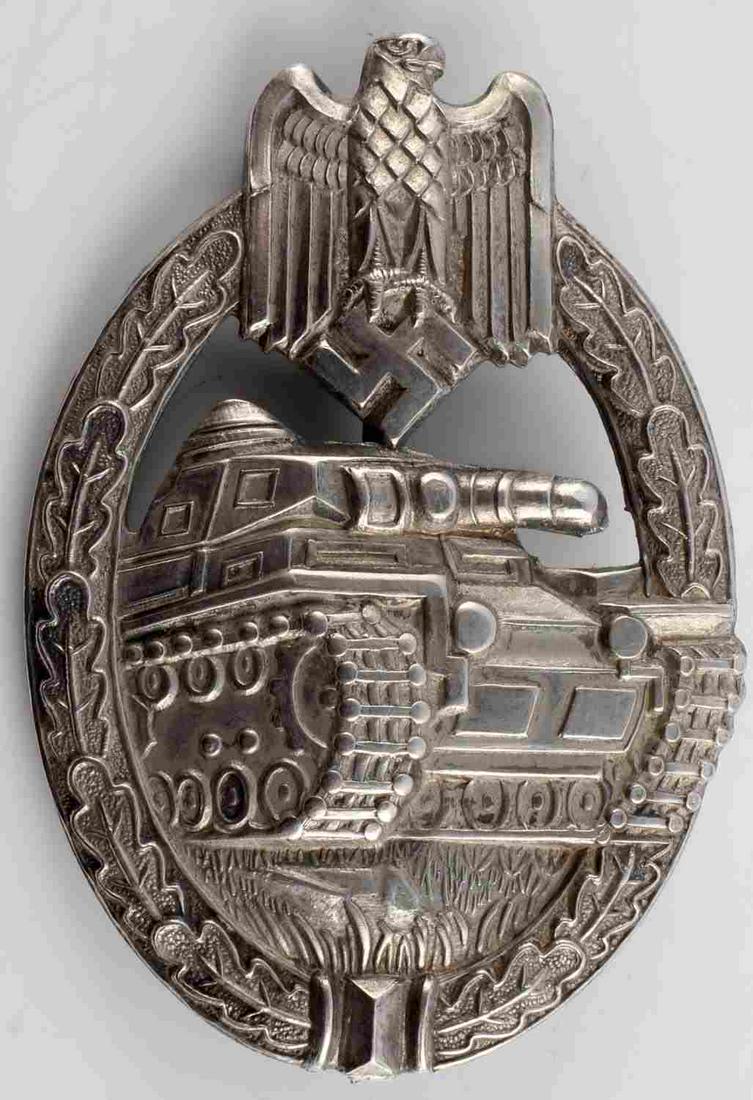 WWII GERMAN THIRD REICH PANZER ASSAULT BADGE: WWII German Third Reich Panzer assault badge. Measures approximately 2.25 X 1.5 inches. Item is magnetic with silvered finish. Obverse shows Eagle clutching swastika, tank, and oak leaf wreath. Vertic
