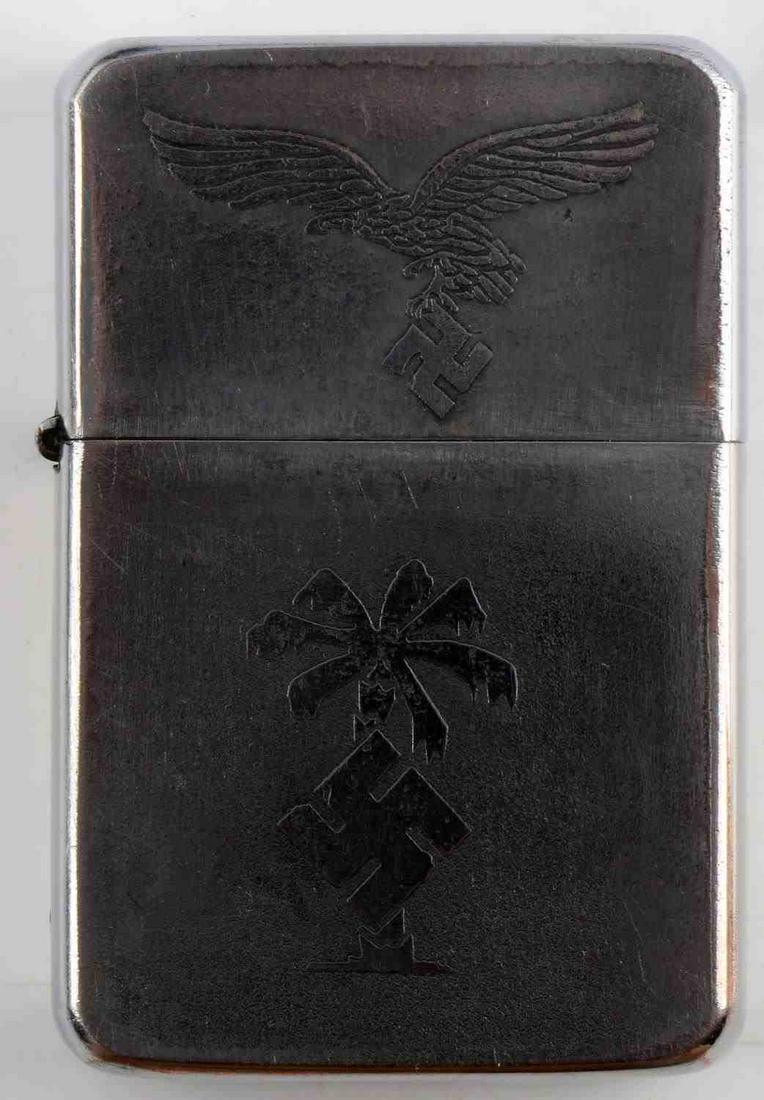 WWII GERMAN THIRD REICH AFRIKA CAMPAIGN LIGHTER: WWII German Third Reich Afrika Campaign Cigarette Lighter. Measures approx. 2.25X1.5 inches. Obverse displays the Afrika Korps palm tree insignia and NSDAP symbol. Zippo style lighter, smoothly opens