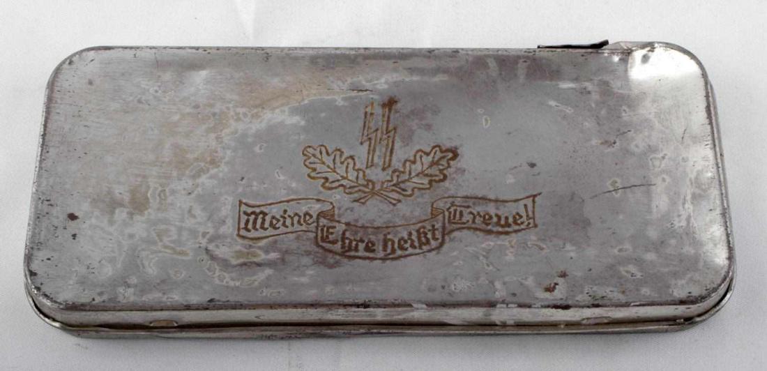 WWII GERMAN THIRD REICH WAFFEN SS TRINKET BOX: WWII German Third Reich Waffen SS Trinket Box. Measures approx. 3X6.5 inches. Box lid shows SS insignia with maple leaves, lid reads "Meine Ehre heißt Treue!" No visible markings on interior. Indenta