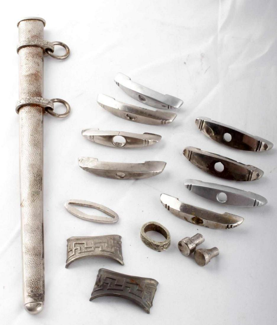 WWII GERMAN REICH LOT OF DAGGER PARTS & SHEATH: WWII German Reich lot of dagger parts to include 8 lower crossguards with no markings, two pommel screws, a ferrule for a heer dagger, a sheath band for a SS chained dagger, and and a Heer dagger shea