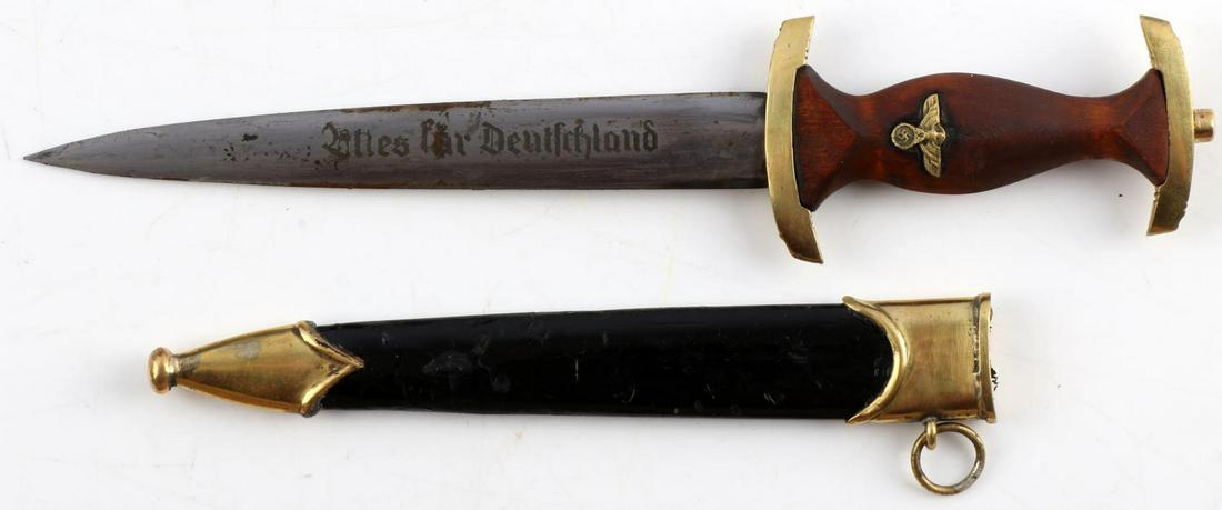 WWII GERMAN THIRD REICH NSKK SA MINIATURE DAGGER: WWII German Third Reich NSKK SA Miniature Dagger, measures approx. 7.25 inches in total length with a 2 inch handle and 4 inch blade. Blade reads "Alles Fur Deutschland." Brown handle is wood construc