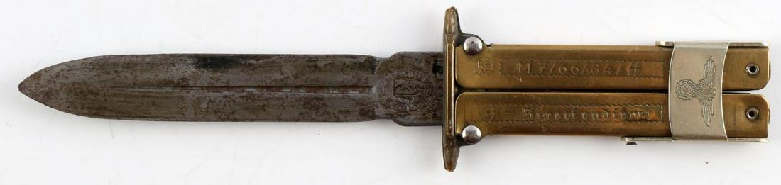 WWII GERMAN THIRD REICH PARATROOPER FOLDING KNIFE: 4 inch blade, the casing is engraved with M7/66/34/SS SS- Streifendienst. Measures 7 3/4 inches. Unauthenticated, sold as is.