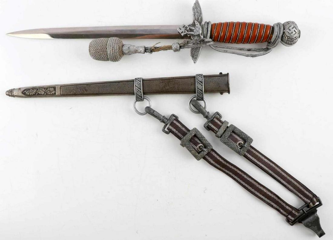 WWII GERMAN LUFTWAFFE OFFICER'S DRESS DAGGER: WWII German Luftwaffe officer's dress dagger in good condition with scabbard, hangers, and portapee. Blade in good condition, some finish loss on lower half. Marked on ricasso "Emil Voos Solingen". Cr