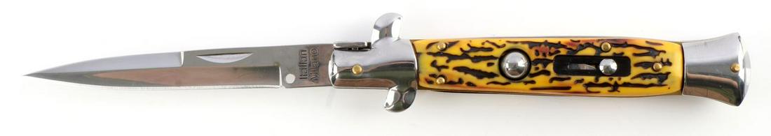 MILANO ITALIAN SWITCHBLADE STILETTO AUTOMATIC: Steel blade, stag styled plastic grip, brass bolsters, with push button. Blade marked Italian Milano. Measures 9 1/2 inches. Very good condition.