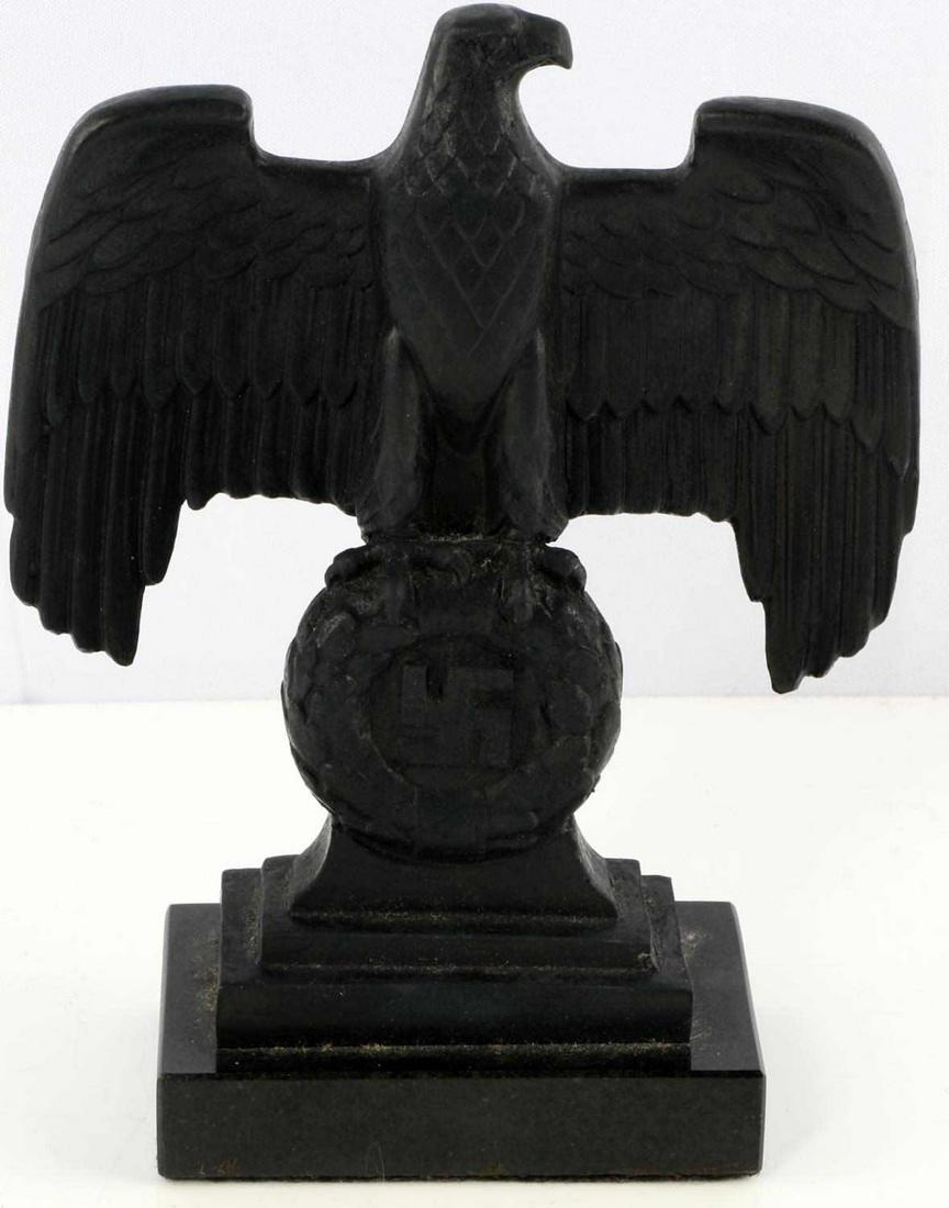 WWII GERMAN THIRD REICH DESK EAGLE ORNAMENT: Eagle clutching oak leaf with swastika atop a granite plinth. No dates or signatures. Measures 7 3/4 inches. Very good condition. This lot has a reserve.