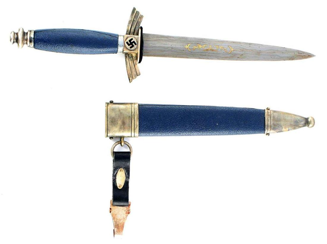 WWII GERMAN REICH LUFTWAFFE DLV DAMASCUS DAGGER: German Third Reich Luftwaffe DLV dagger. Features blue leather scabbard and grip with nickel fittings. Beautiful Damascus blade with raised gold Luftwaffe eagle and laurel leaves. SMF maker with Echt