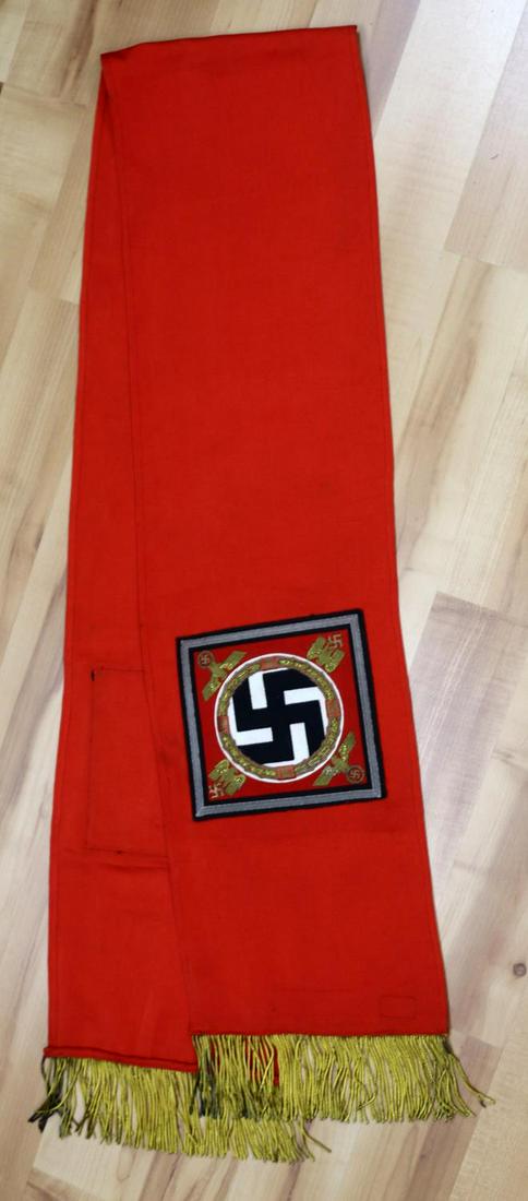 WWII GERMAN REICH HITLER STANDARTE FUNERAL SASH: Third Reich Hitler Standarte funeral sash. Red sash with small standarte flags sewn into the fabric with gold bullion fringe. Measures 77 inches. Minimal fluorescing. SS and RZM tags sewn on reverse. 