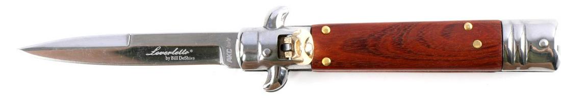 BILL DESHIVS SWITCHBLADE LEVERLETTO AUTO KNIFE: Italian made AKC lever action automatic switchblade knife with 3.25 inch D2 steel blade and wood handle, overall length 7.5 inches. Unused condition