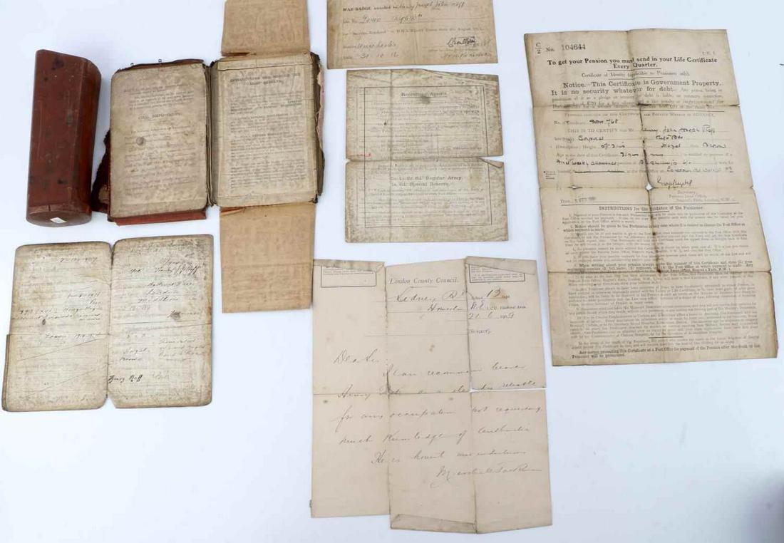 WWI SOLDIER DISCHARGE DOCUMENTS & 1909 SLR DIE: Document lot in fairly frail condition of a British Rifles soldier, wound history, discharge and voucher for character papers, also Drop Die shape, for Model 1909 SLR receiver.