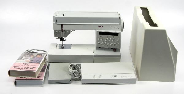 PFAFF MODEL 1473 SEWING & EMBROIDERY MACHINE: A model 1473 Pfaff sewing and embroidery machine with Creative Designer attachment, instruction booklets and videos, spare needles, and bobbins. Very good condition.